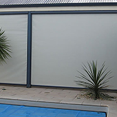 roller screens on veranda near pool